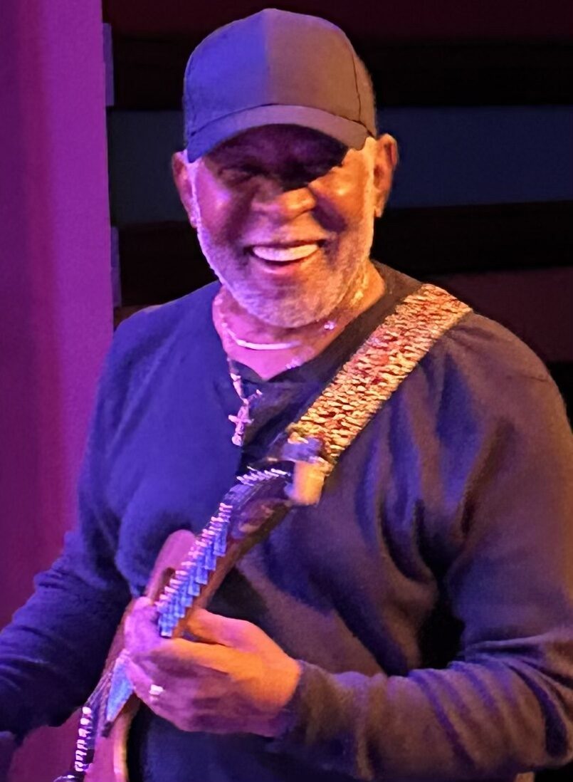 Boots Anderson smiling with guitar