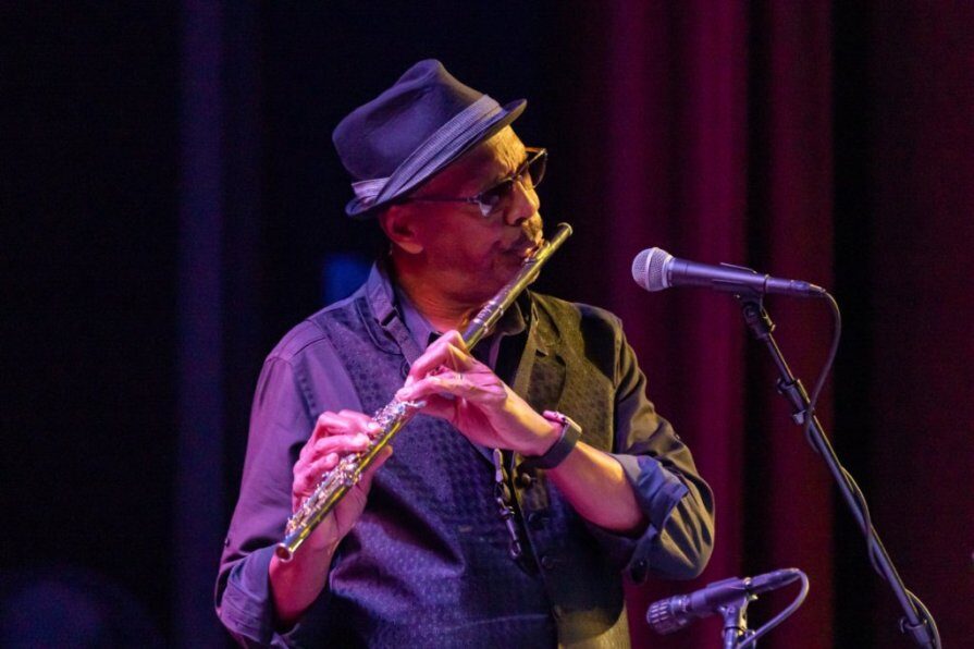 Robin Corley playing flute on stage