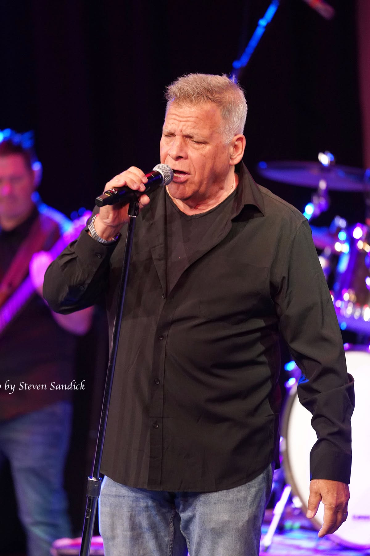 Jim DeRosa singing on stage