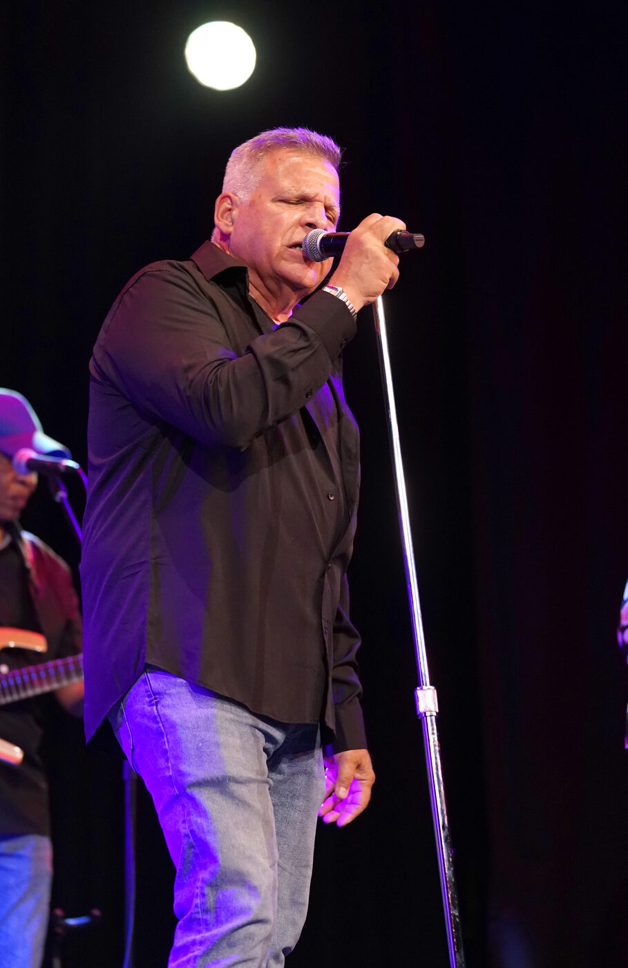 Jim DeRosa singing on stage