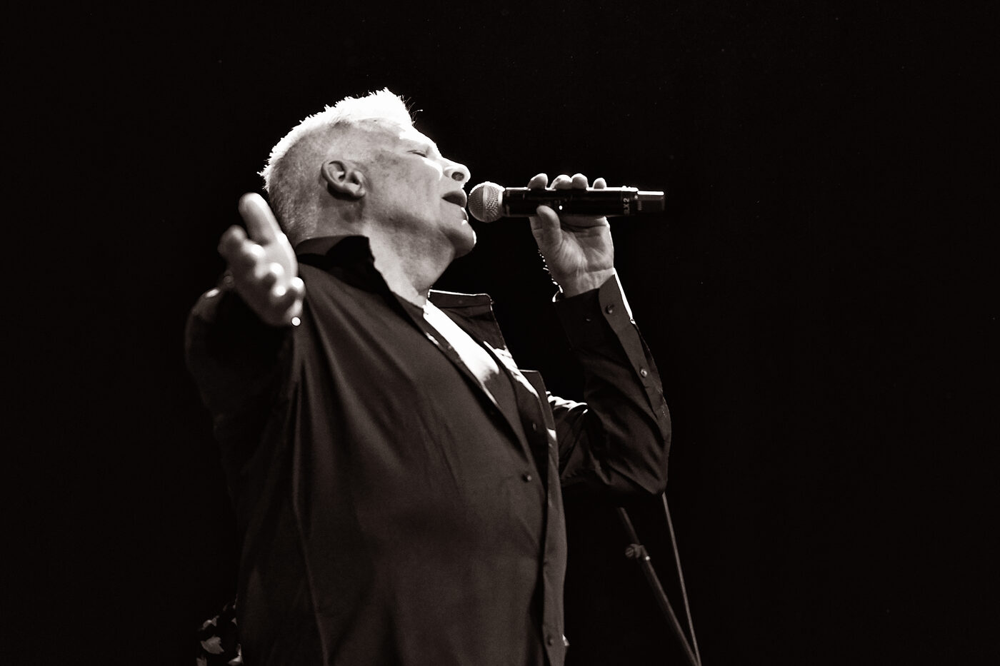 Black and white photo of Jim DeRosa singing