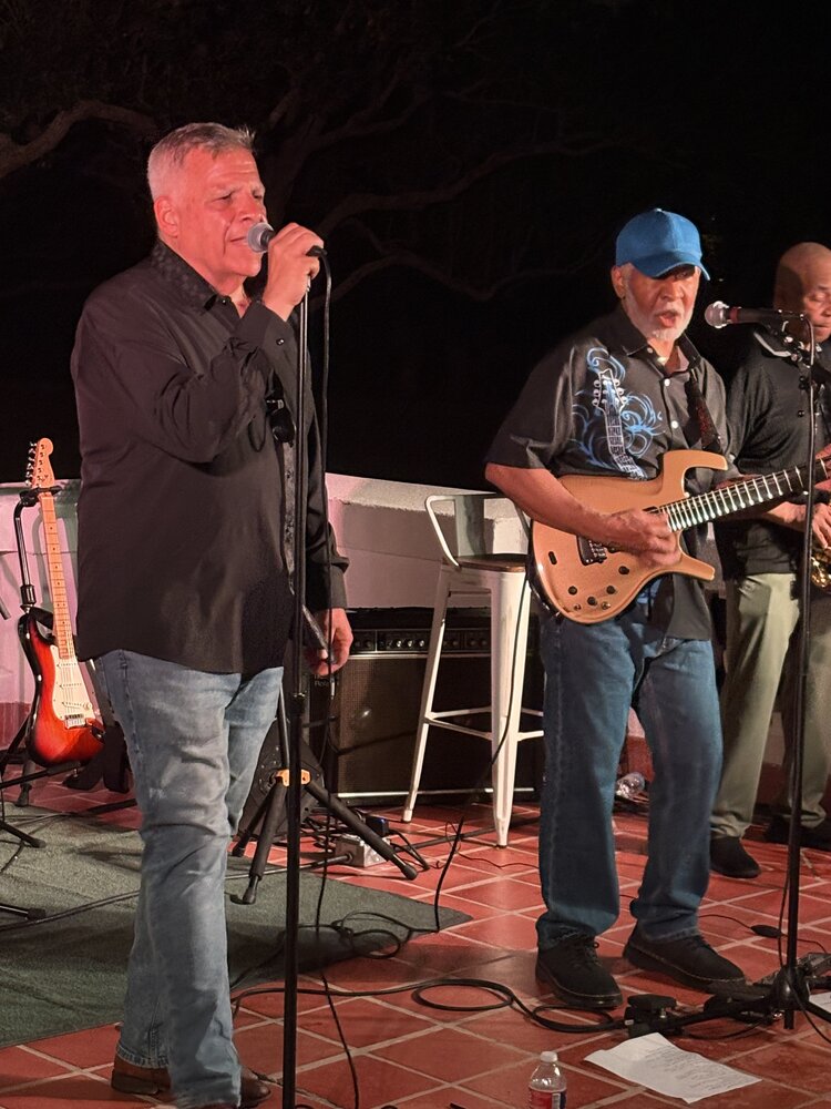 Jim DeRosa, Boots Anderson, and Darryl Dixon performing outdoors