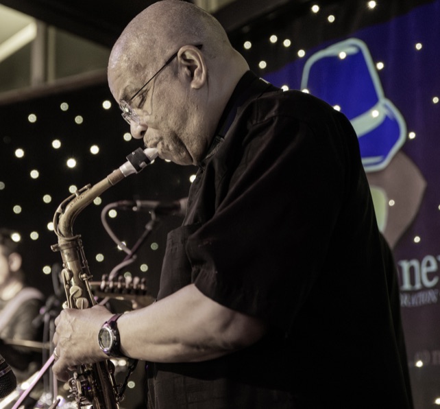 Saxophone player performing on stage